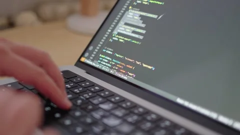 Programmer Coding on Laptop with Syntax Highlighting Stock Footage 278728987