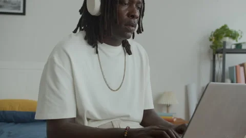 Programmer Coding on Laptop when Working from Bedroom Stock Footage 300829109