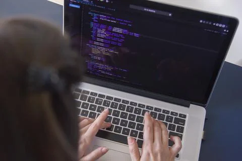 A programmer coding on a laptop in the workplace 写真素材