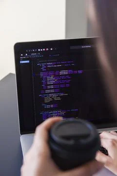 A programmer coding on a laptop in the workplace 写真素材