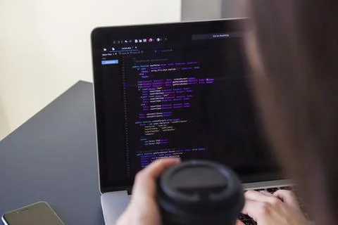 A programmer coding on a laptop in the workplace 스톡 사진