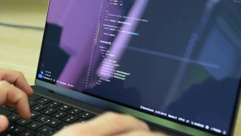 A programmer coding software in a code editor on his laptop(with original audio) Stock Footage 311644105