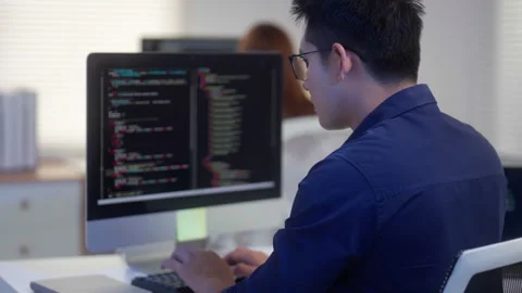 Programmer Coding Software on a Computer in Modern Office Vídeos de archivo 343623948