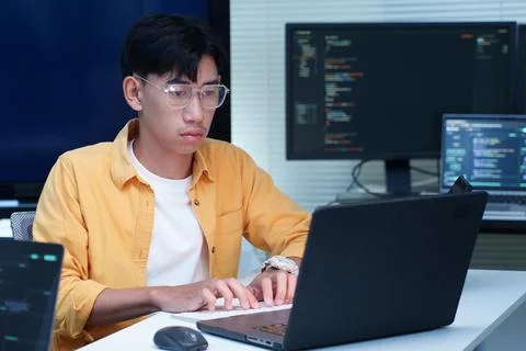 Programmer Coding Software on Laptop in Technology Office 写真素材