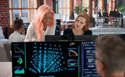 Programmer Collaborates With Diverse Team Analyzing AI Data For Security. Stockfoto's