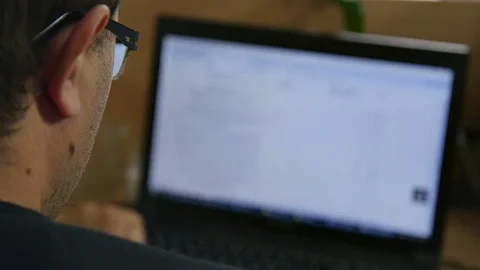 Programmer at the Computer Looking at Monitor Stock Footage 76423817