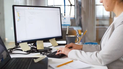 Programmer at computer working and drinking coffee Stock Footage 105032203