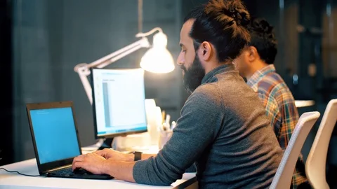 Programmer with computers working at night office Stock-Footage 99044577