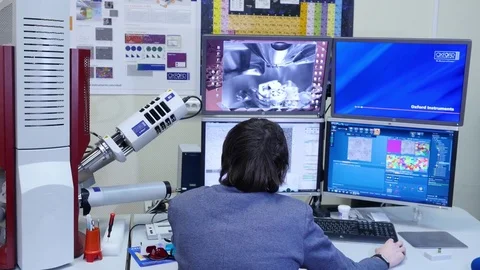 Programmer configures the computer for bitcoin mining. Programmers are watching Stock-Footage 77925362