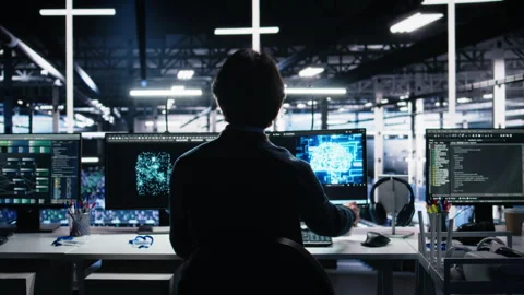 Programmer in data center coding with generative AI assistance Stock Footage 313566721