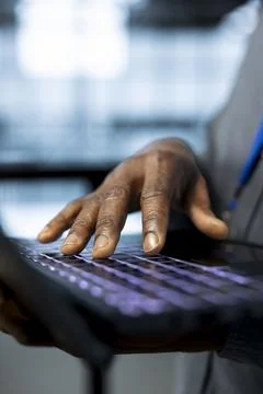 Programmer in data center facility typing on laptop keyboard, close up 스톡 사진