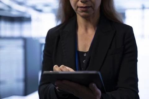 Programmer in data center implementing backup solutions using tablet Stock Photos