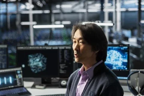 Programmer in data center optimizing infrastructure for AI tasks Stock Photos