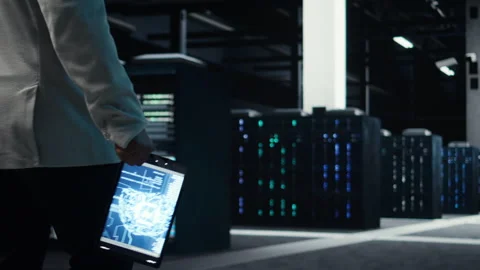 Programmer in data center using artificial intelligence tech on tablet Stock-Footage 311833689