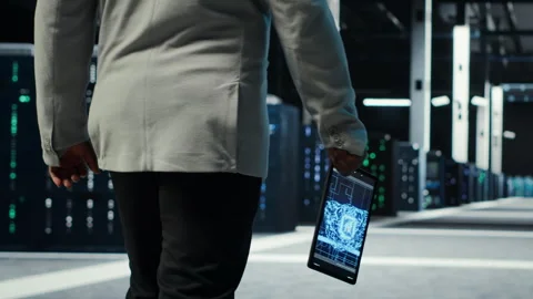 Programmer in data center using artificial intelligence tech on tablet Stock-Footage 311963834