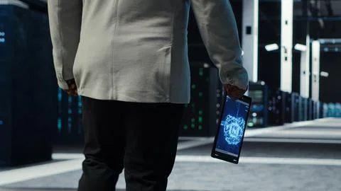 Programmer in data center using artificial intelligence tech on tablet 写真素材
