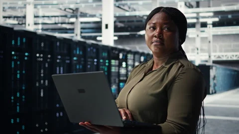 Programmer in data center using laptop to deploy new server architecture Stock-Footage 317124016