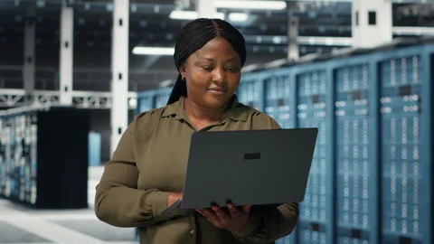 Programmer in data center using laptop to upgrade systems Stock-Footage 317201596