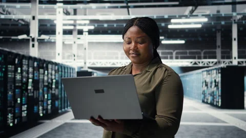 Programmer in data center using laptop to upgrade systems Stock Footage 317203201