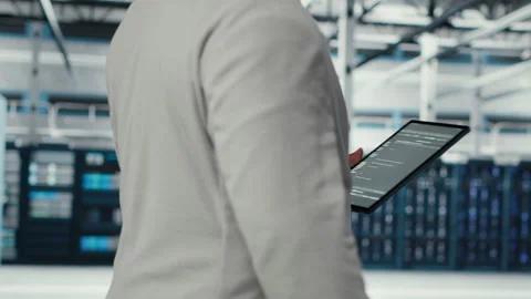 Programmer in data center using tablet to manage software updates Stock-Footage 311959005