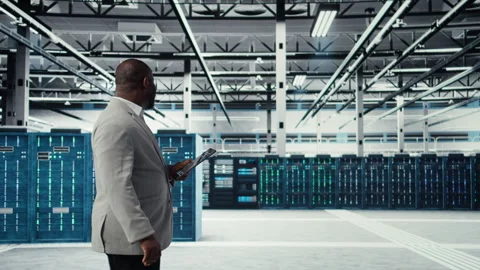 Programmer in data center using tablet to manage software updates Stock-Footage 311963308
