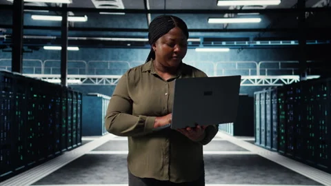 Programmer in data center using tablet to increase workload capacity Stock-Footage 317125367