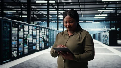 Programmer in data center using tablet to increase workload capacity Stock Footage 317205028