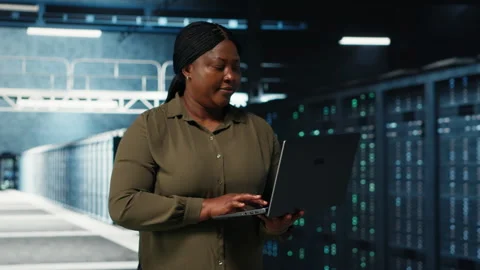Programmer in data center using tablet to increase workload capacity Stock Footage 317206567
