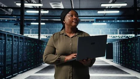 Programmer in data center using tablet to increase workload capacity Stock Photos