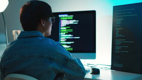 Programmer debugging code on multiple screens Video stock 313808876