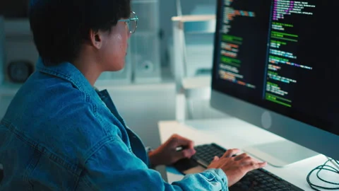 Programmer debugging software code on multi-monitor setup Video stock 313813604