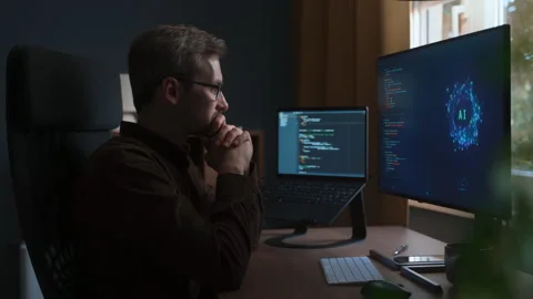 Programmer at desk is excited about new AI assistant coding possibilities Stock Footage 341680607