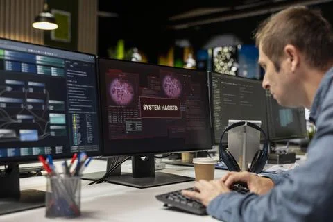 Programmer detecting and blocking hacker spyware virus 库存照片