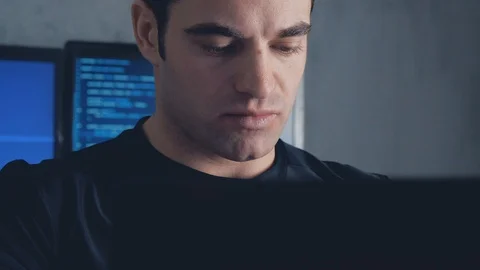 Programmer developer working on a computer at night in the office. Steadicam Stock Footage 102135336