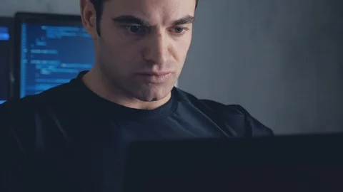 Programmer developer working on a computer at night in the office. Steadicam Stock Footage 102136685