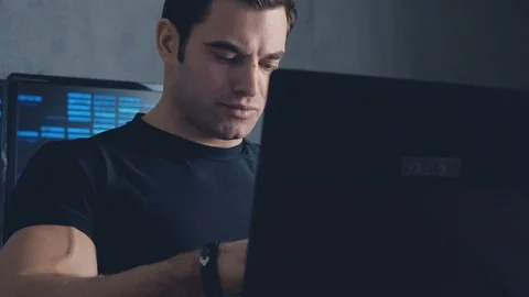 Programmer developer working on a computer at night in the office. Steadicam Stock Footage 102742362
