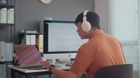 Programmer Developing and Testing Codes on Laptop and Computer Stock Footage 265069485