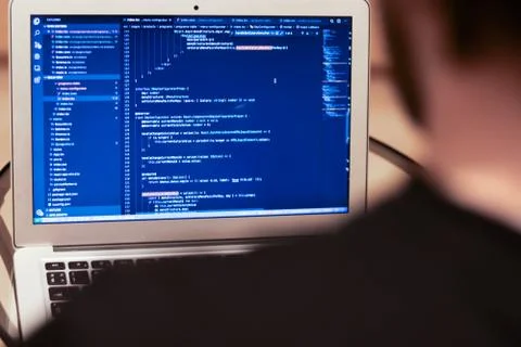 Programmer is developing an application. Programming on a laptop and creating Foto stock