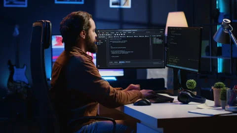 Programmer developing code on computer screen while in personal office Video stock 265511627