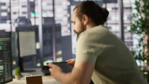 Programmer developing machine learning APIs, checking performance on tablet Stock Footage 318159380