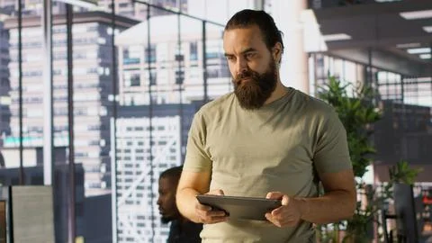 Programmer developing machine learning APIs, checking performance on tablet Stock Photos