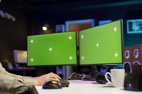 Programmer developing software applications using green screen computer Stock Photos