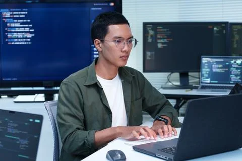 Programmer Developing Software Code in Modern Technology Office Stock Photos