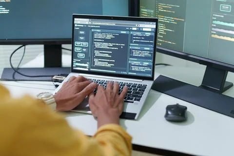 Programmer Developing Software with Code on Multiple Monitors Stock Photos