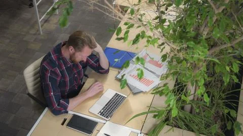 Programmer dials the code and thinks how to solve the problem. 스톡 사진