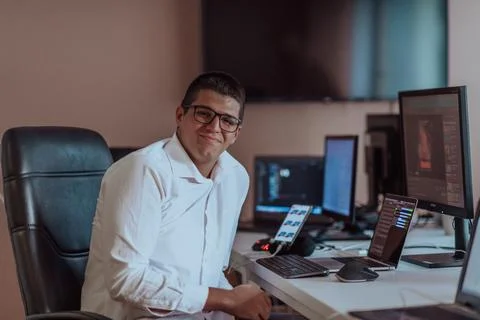 A programmer diligently testing smartphone applications while sitting in their 스톡 사진