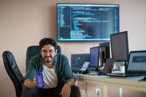 A programmer diligently testing smartphone applications Stock Photos