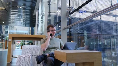 Programmer discussing a project on the phone - Developer Stock Footage 278913958