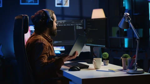 Programmer does multitasking, drinks coffee, listens music Stock Footage 265619685