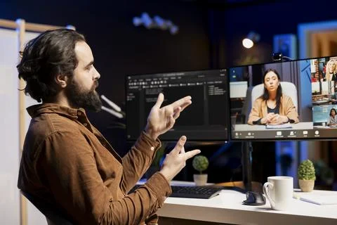 Programmer doing online tutoring, teaching students in videocall to do debugging Stock Photos